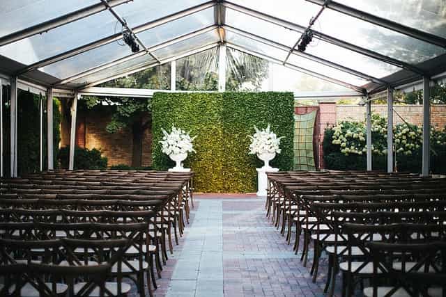 Outdoor wedding event space with clear tent and floral arrangements in Chicago.