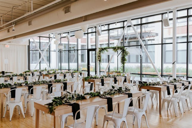 Meeting planning service in Greenhouse Loft with elegant table settings and natural light.