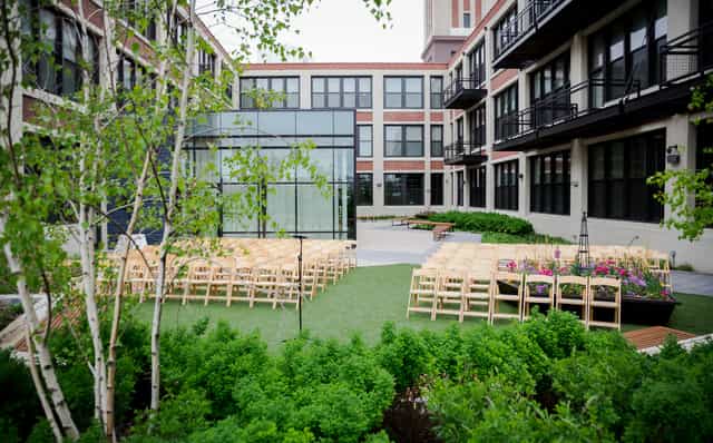 Outdoor event space with wooden chairs at Greenhouse Loft for weddings and corporate events.