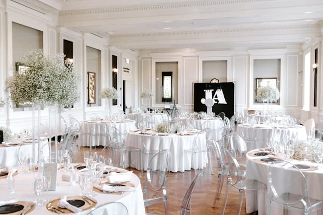 Elegant Chicago History Museum event space with white tables and modern acrylic chairs.