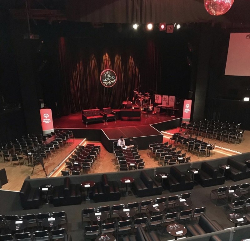 Auditorium in Park West set for a professional panel discussion with lounge seating.