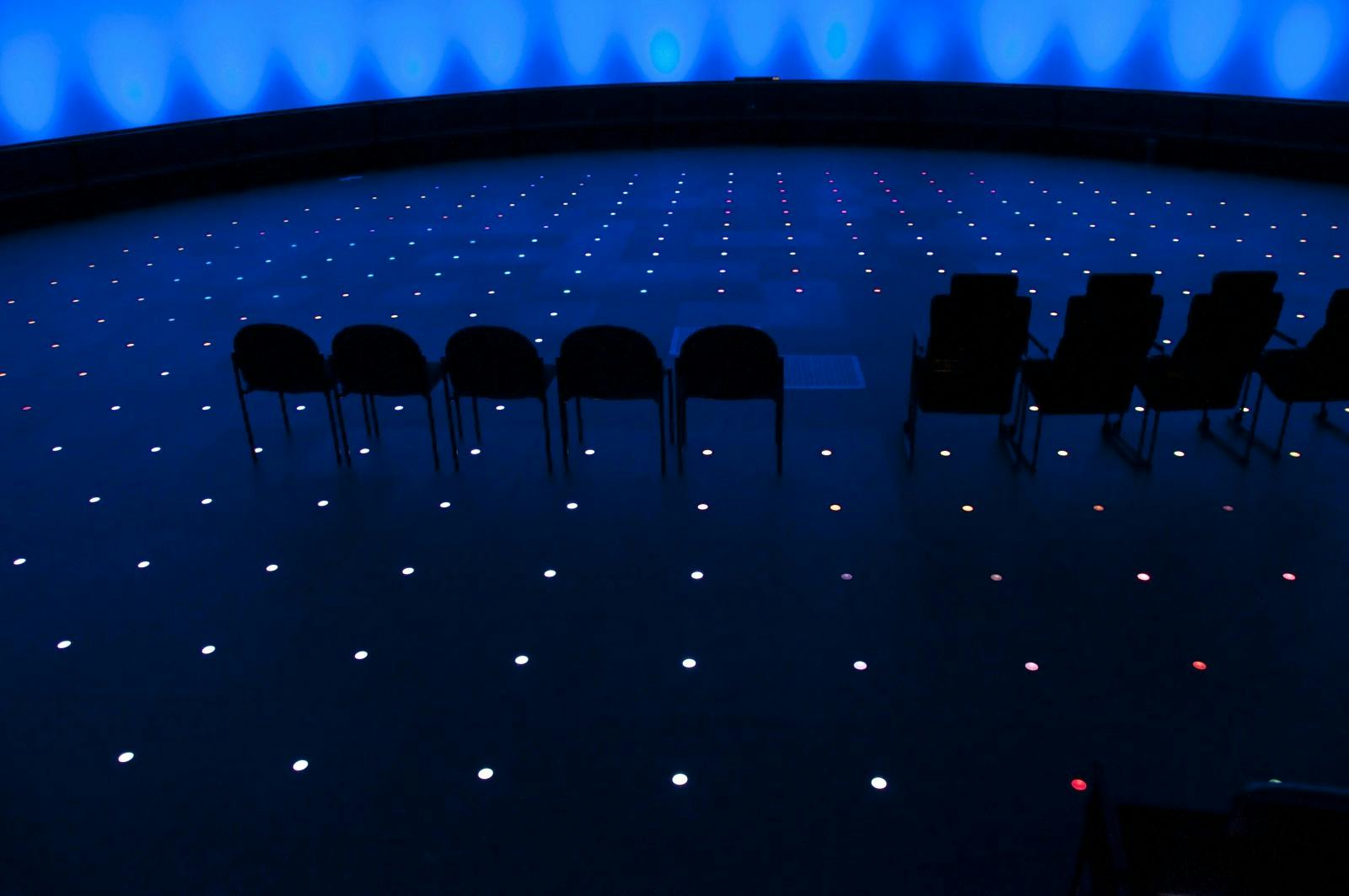 Grainger Sky Theater at Adler Planetarium, modern event space with blue lighting.