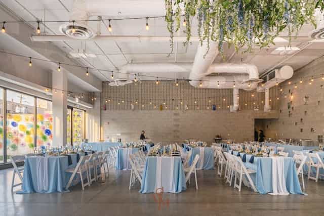 Modern banquet event space with blue linens, ideal for weddings and corporate events.