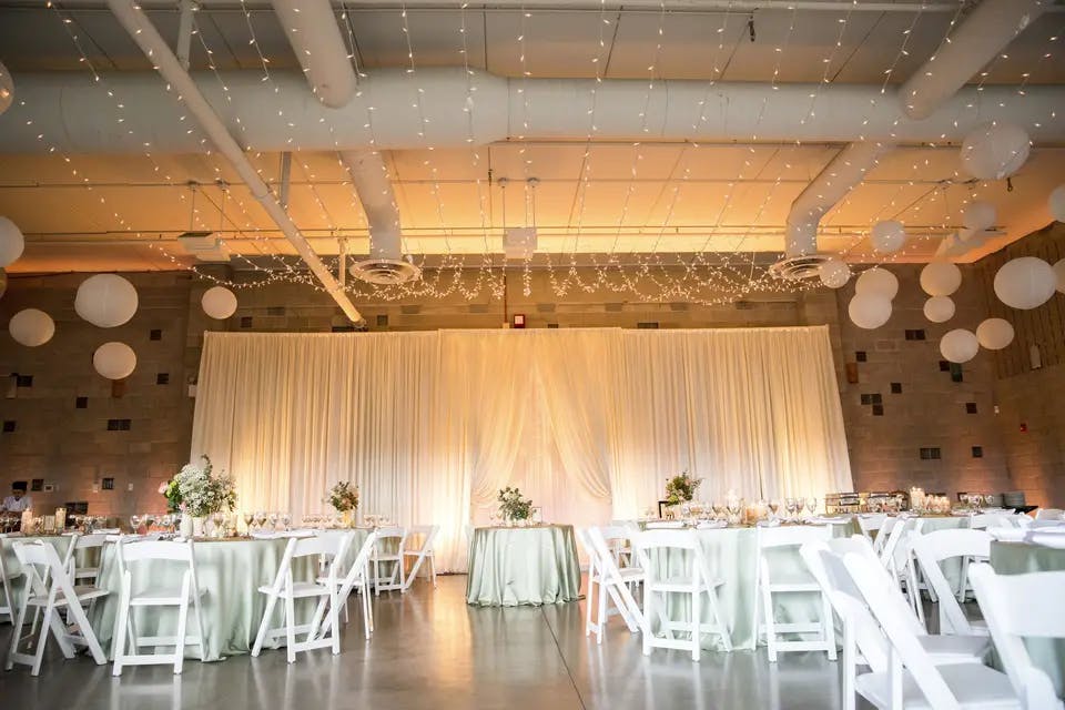 Elegant rooftop deck event space with soft lighting, ideal for weddings and gatherings.
