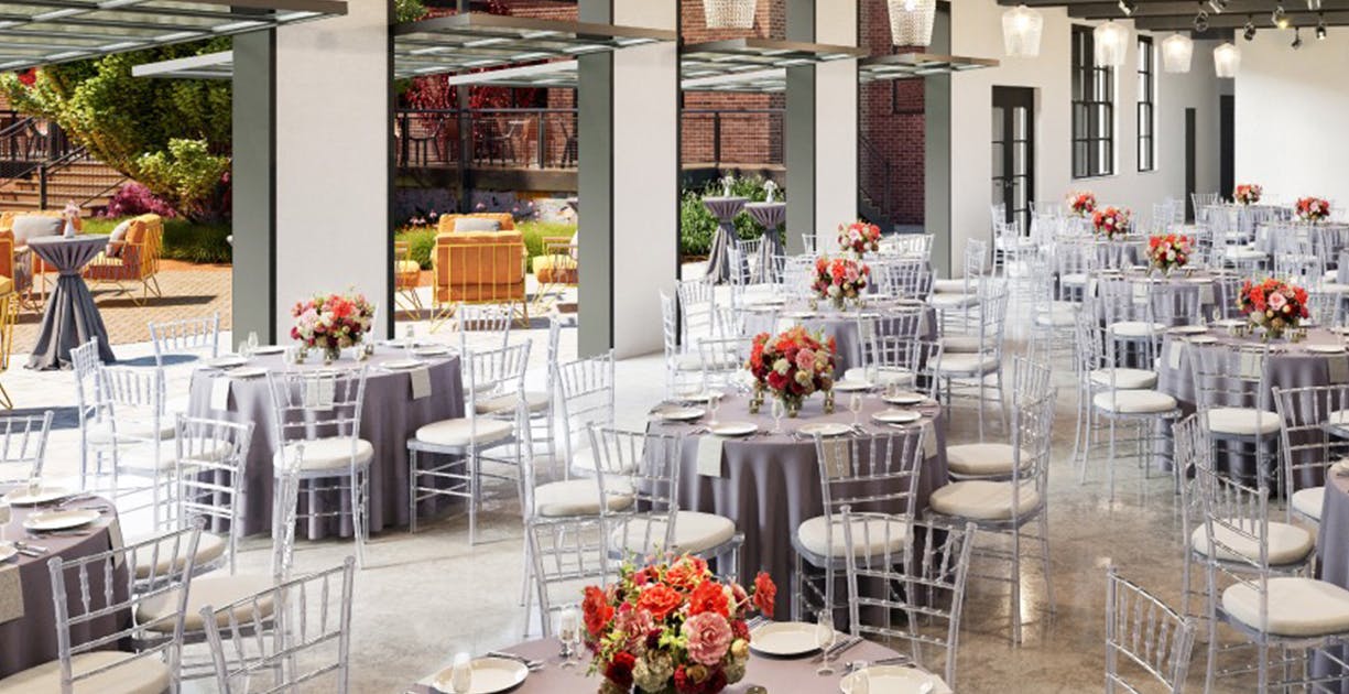 Elegant outdoor terrace with floral centerpieces, perfect for weddings and corporate events.