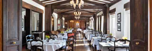 Skyline Lounge dining space with elegant chandeliers for upscale events and gatherings.