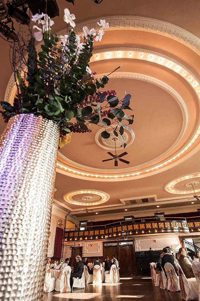 Elegant banquet hall with crystal vase centerpiece, ideal for upscale celebrations.