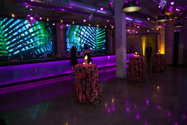 Vibrant Mezzanine event space with sleek bar, ideal for cocktail receptions and gatherings.