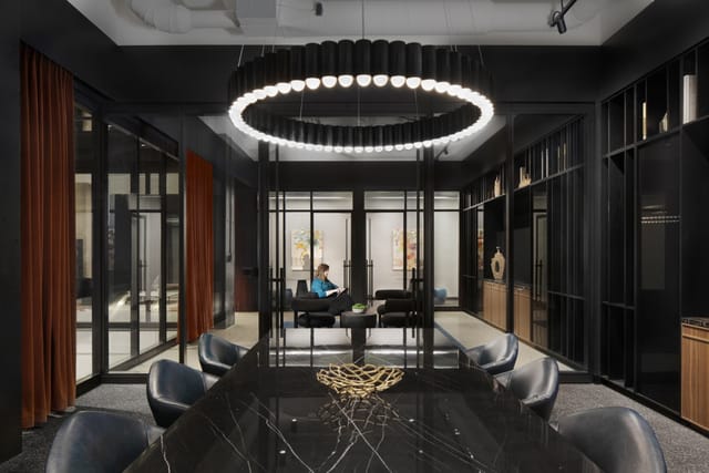 Modern meeting space in Founder's Room, featuring elegant black table and stylish seating.