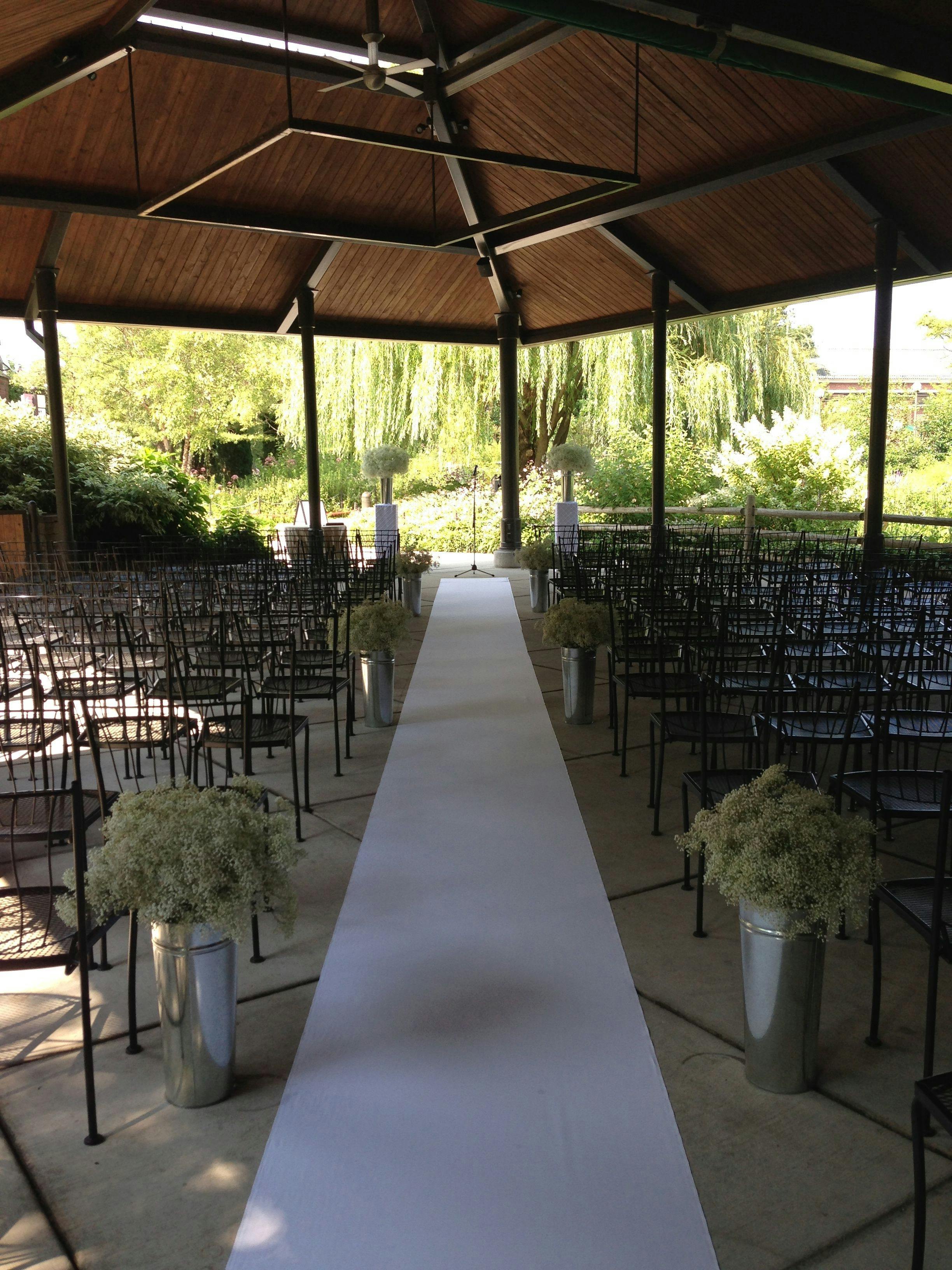 "Foreman Pavilion outdoor wedding venue with greenery and elegant floral arrangements."