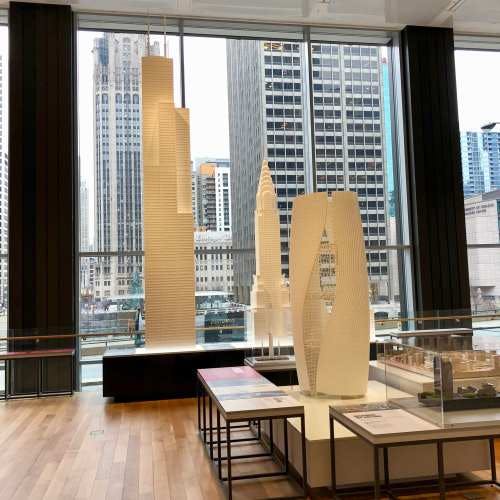 Modern event space at CAC Galleries, featuring skyline views and architectural models.