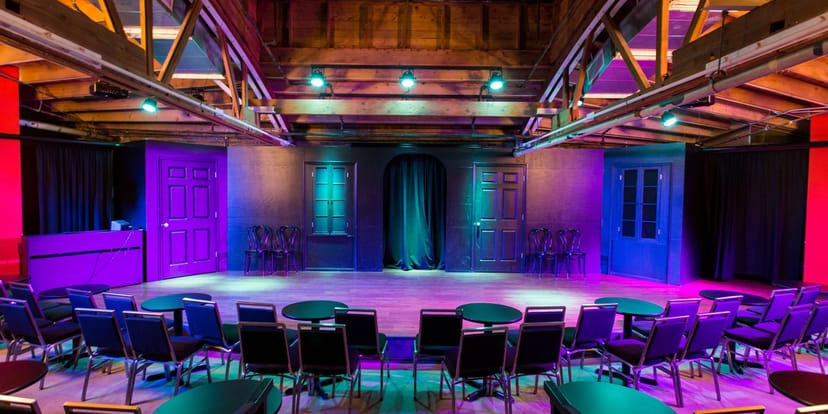 Versatile event space at iO Theater with vibrant lighting for dynamic gatherings.