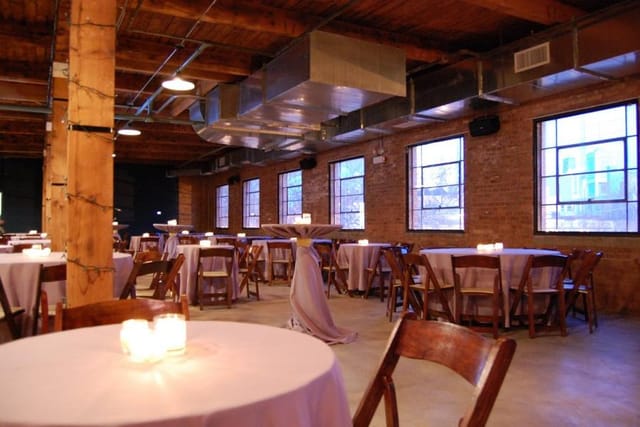 Versatile event space at iO Theater with exposed brick, ideal for networking and receptions.