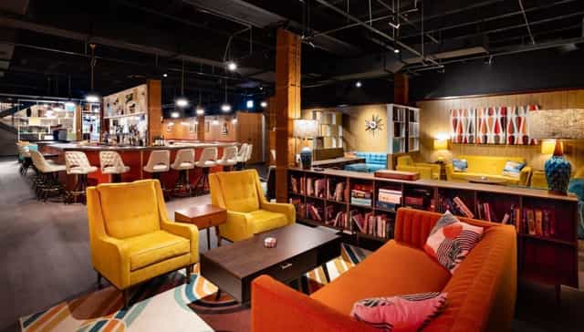 Vibrant iO Theater lounge with colorful seating for networking events and brainstorming.