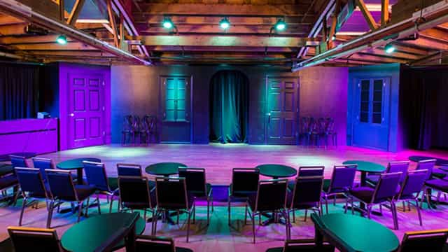 Comedy club at iO Theater with vibrant stage lighting for events and performances.
