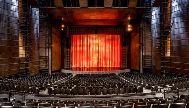 Harris Theater auditorium with red curtain, ideal for concerts and presentations.