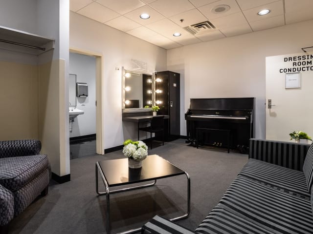 Donor Room at Harris Theater: elegant dressing room with piano for pre-event preparations.