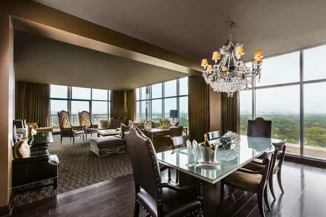 Elegant meeting space at Hotel ZaZa Houston with chandelier and panoramic views.