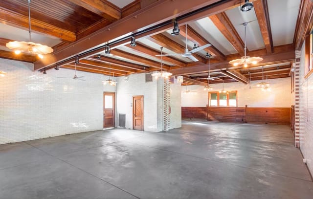 Coach House event space with rustic beams, ideal for gatherings and meetings.