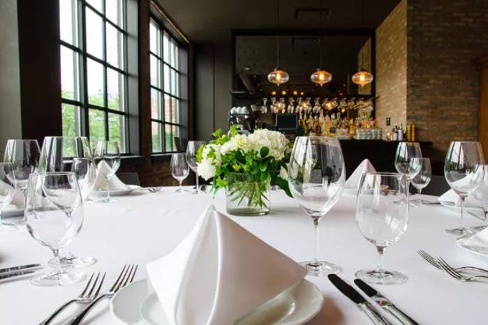Elegant dining table with floral centerpiece for corporate events in Formento's loft.
