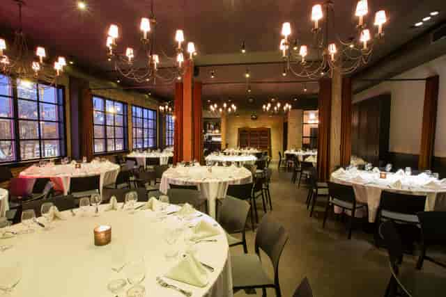 Sophisticated dining loft with elegant tables, ideal for events and networking.