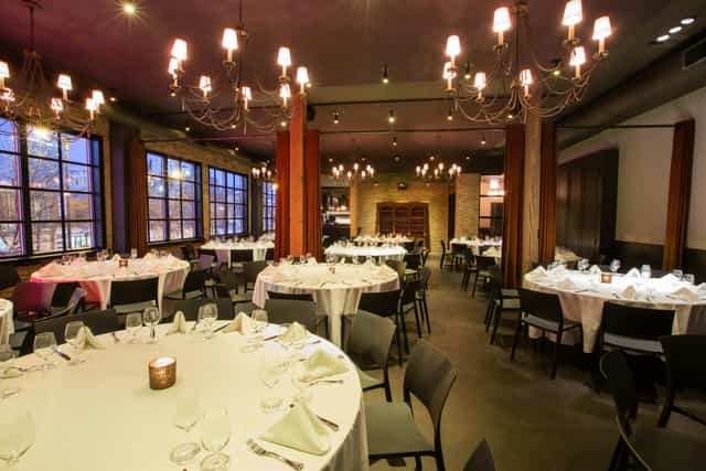 Sophisticated dining loft with elegant tables, ideal for events and networking.