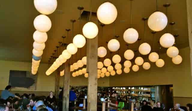 Vibrant bar with unique pendant lighting, perfect for casual meetings and networking events.