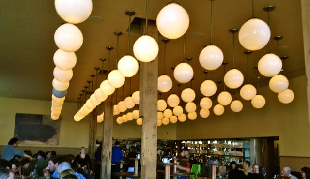 Vibrant bar with unique pendant lighting, perfect for casual meetings and networking events.