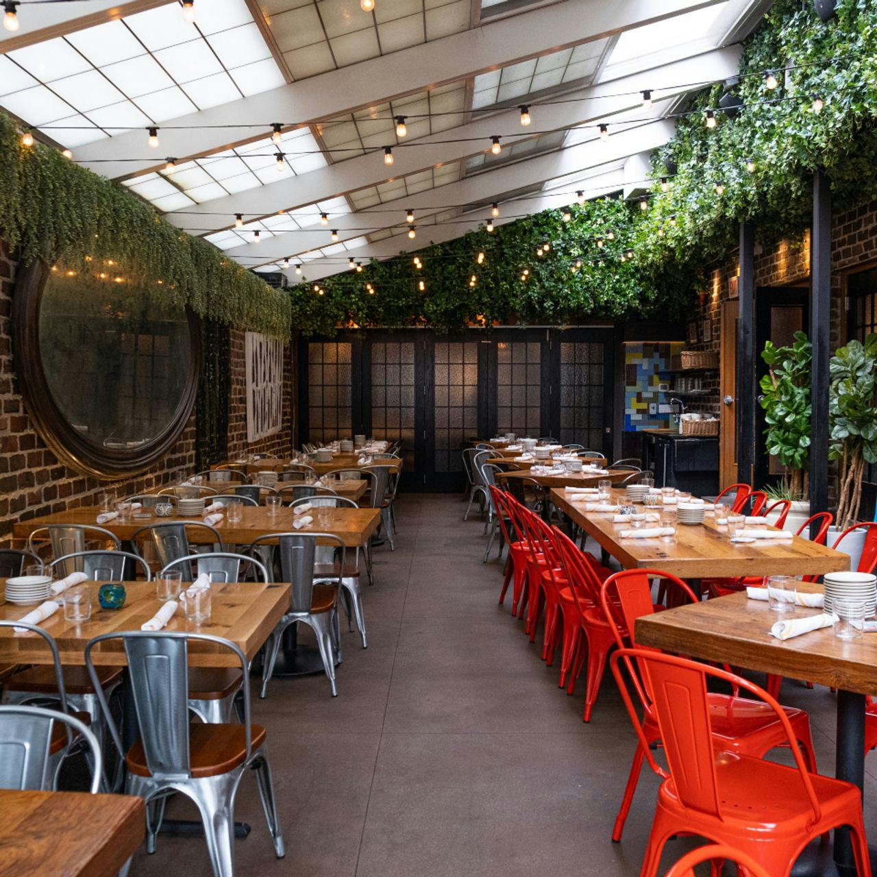Stylish event space at Cafe Ba-Ba-Reeba! with rustic decor and greenery for gatherings.
