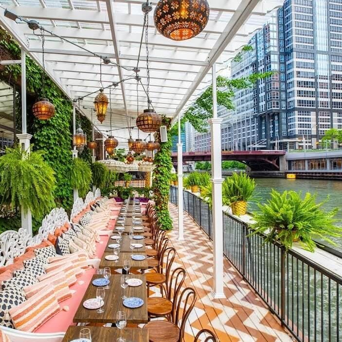 Dual Floor Private Buyout at Beatnik On The River, elegant outdoor dining with lush greenery.