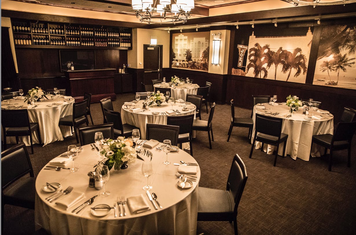 Private dining room at Joe's Seafood with elegant tables, perfect for corporate events.