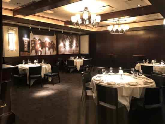 Elegant private dining room with round tables for intimate gatherings and corporate events.