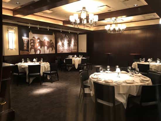Elegant private dining room with round tables for intimate gatherings and corporate events.