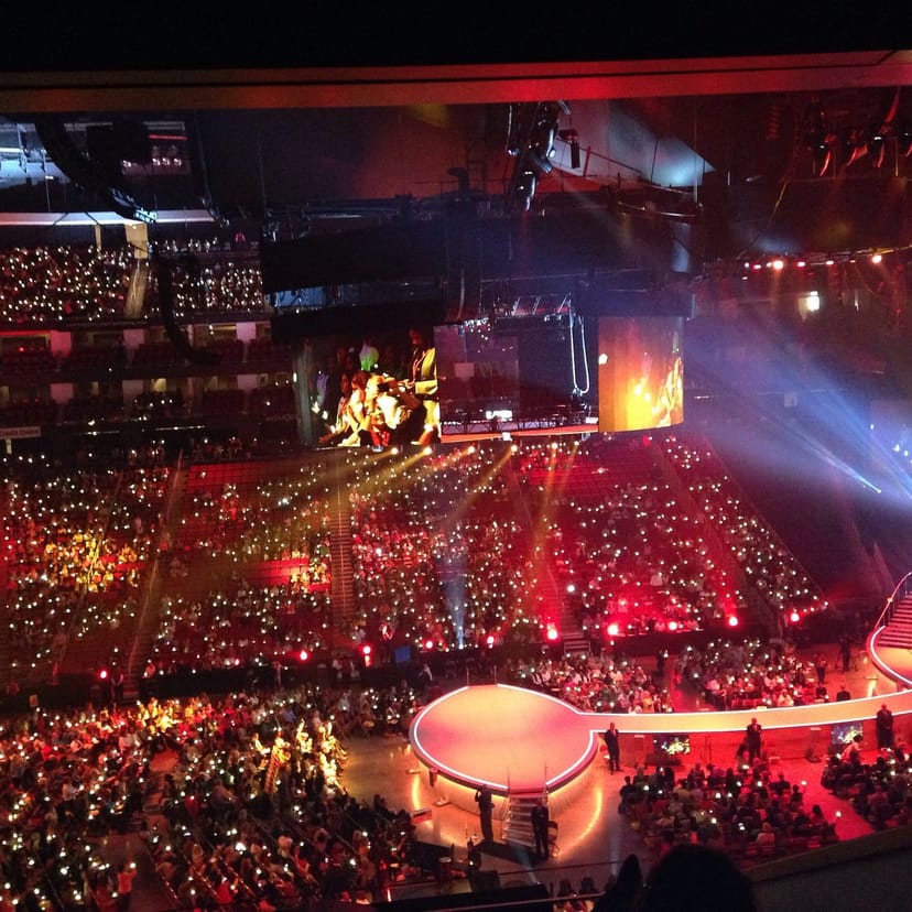 Houston Toyota Center arena with engaged audience at a dynamic event, vibrant lighting.