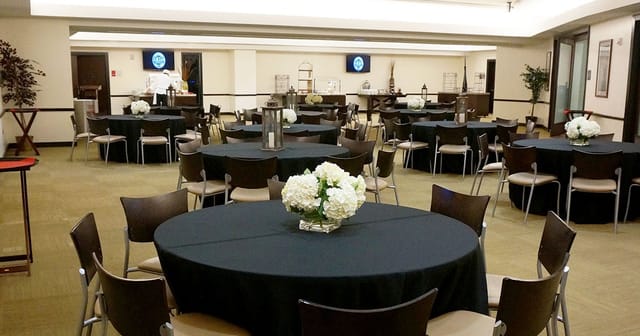 VIP banquet space in Houston Toyota Center with elegant floral centerpieces for corporate events.