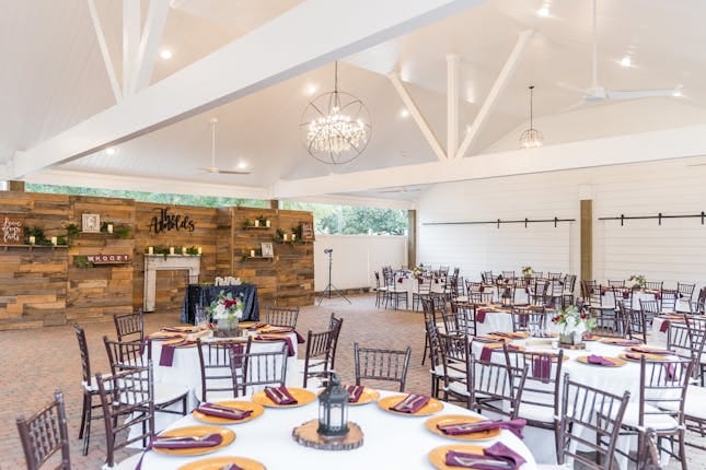Elegant event space with round tables, ideal for weddings and corporate gatherings.