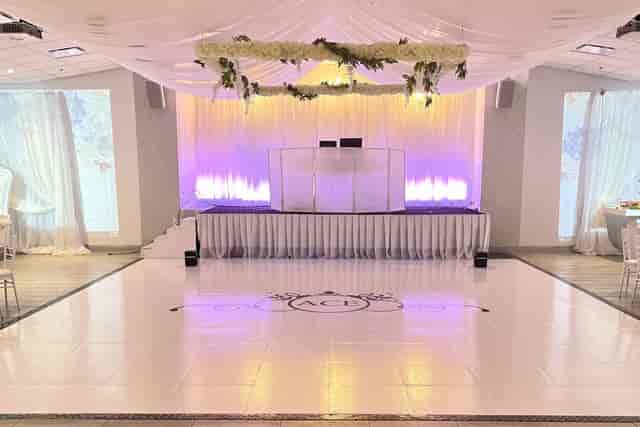 Elegant banquet hall with dance floor, ideal for weddings and corporate events.
