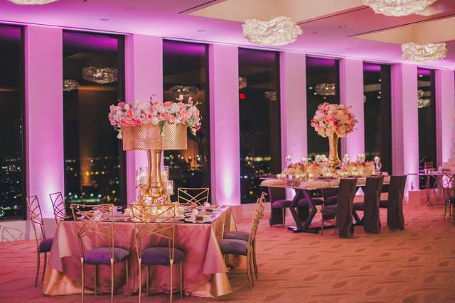 Elegant grand ballroom with floral centerpieces, perfect for weddings and corporate events.