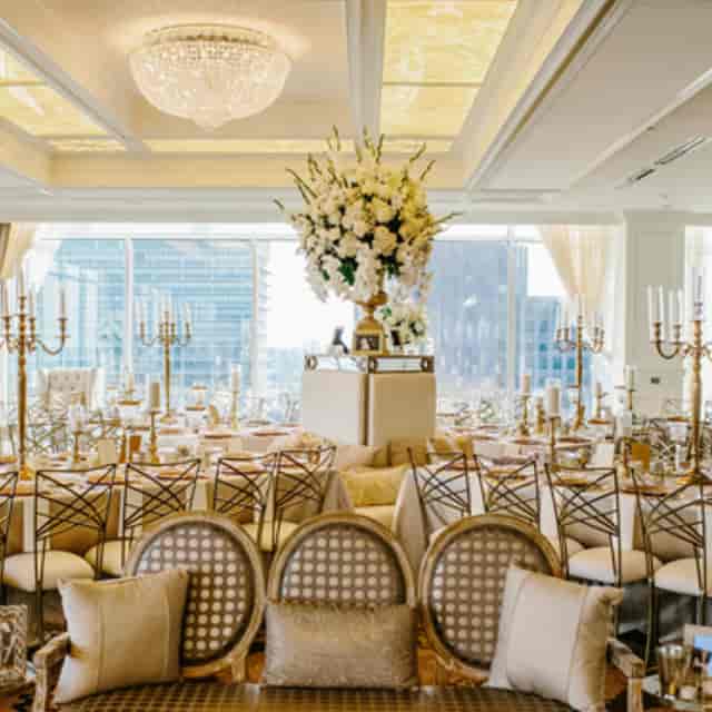 Elegant wedding banquet space with floral centerpiece and gold accents, ideal for upscale events.