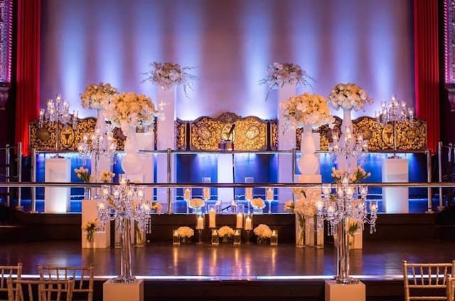 Elegant banquet hall with floral arrangements, ideal for ceremonies and galas.