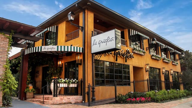 Charming event venue with vibrant exterior and outdoor space for gatherings.
