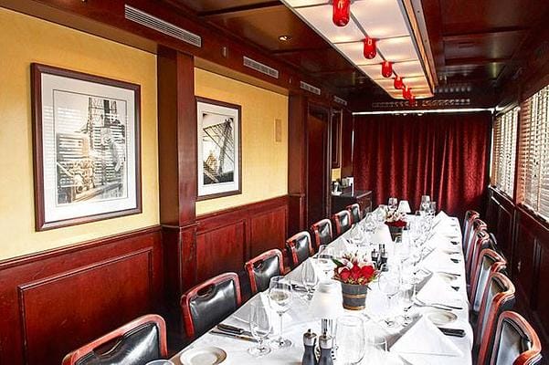 Elegant private dining room with rich wood paneling for upscale events and meetings.
