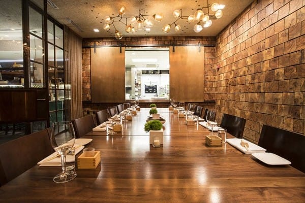 Private dining room at Uchi with a long wooden table for intimate networking events.