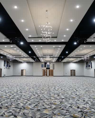 Civic Center at LOEH: spacious event hall with modern chandeliers for conferences and banquets.