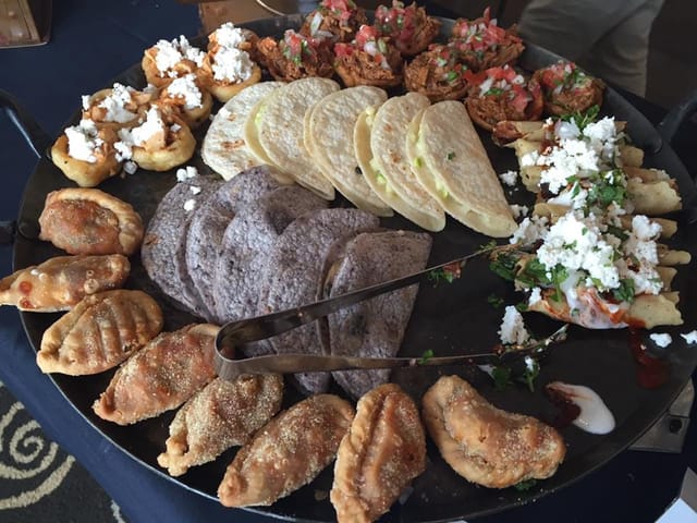 Vibrant platter of empanadas and tacos for catering at events and celebrations.