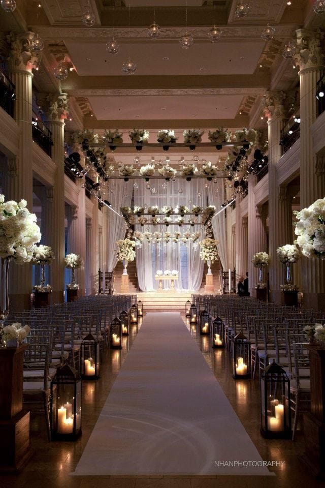 Elegant wedding ceremony setup in Corinthian Houston with floral arrangements and candles.