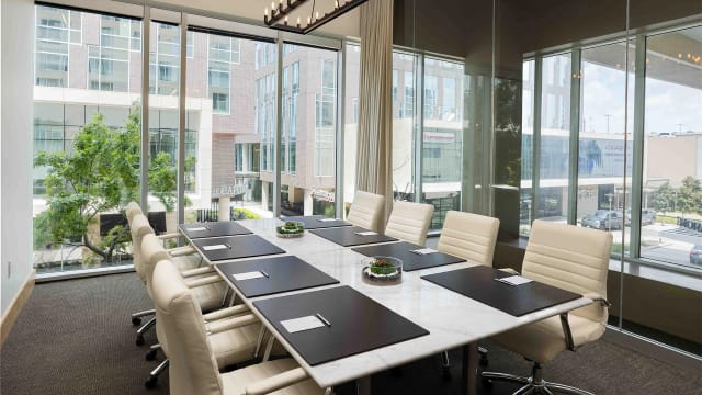 Modern conference room at The Moran Meeting & Event Center with marble table and natural light.