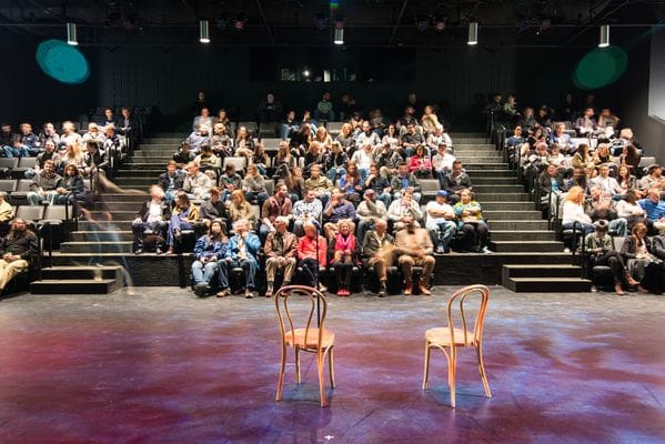 Engaged audience in tiered seating at MATCH Theater 2 for a workshop or panel discussion.