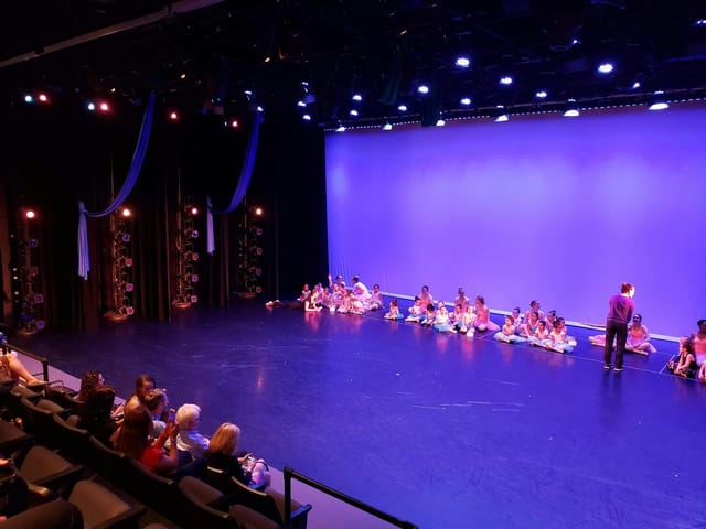 Well-lit stage in MATCH Theater 2, perfect for dance recitals and performances.
