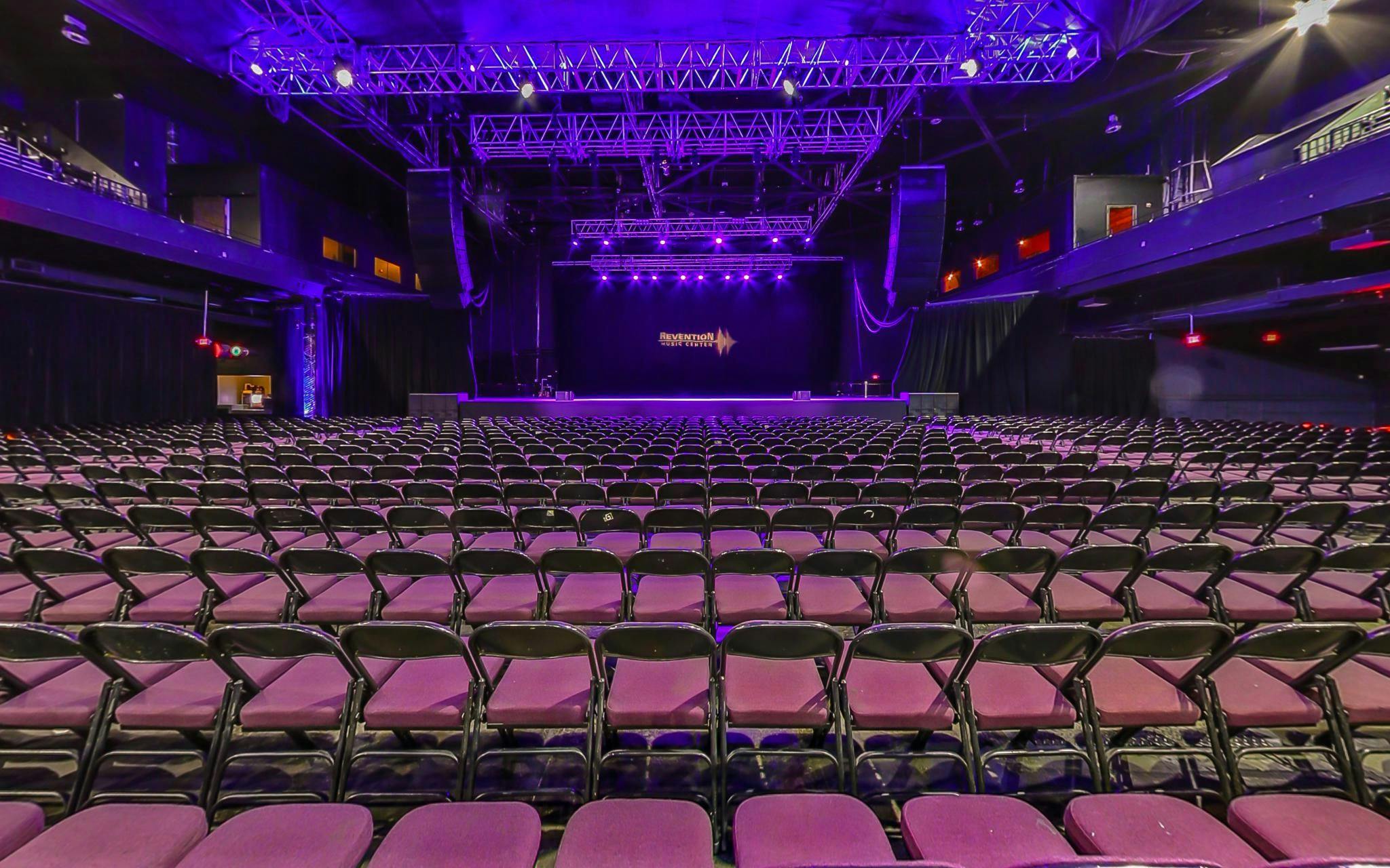 Bayou Music Center auditorium with black chairs, perfect for concerts and conferences.